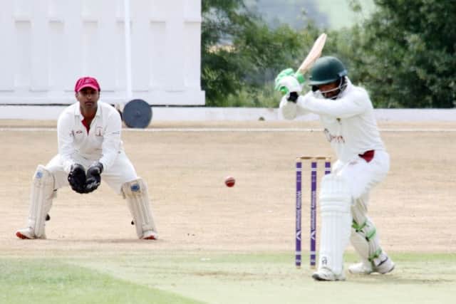 Banbury wicket keeper Shazad Rana looks on as Slough batsman Shahid Yousaf lets one go through