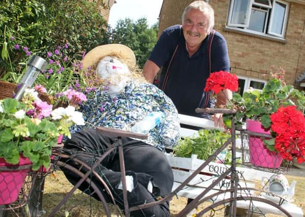 Roger Davis standing with his scarecrow to be judged at Tadmarton Scarecrow Show NNL-180722-190057009