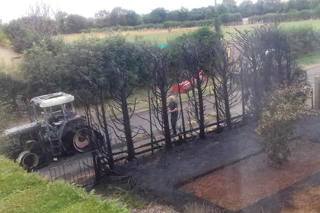 A firefighter at the scene of the blaze in Shenington which destroyed the tractor and front garden. Photo: Mick Haynes