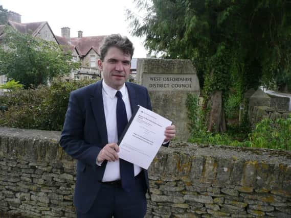 West Oxfordshire District Council leader James Mills holding the planning inspectorate's report approving its Local Plan NNL-180829-111902001