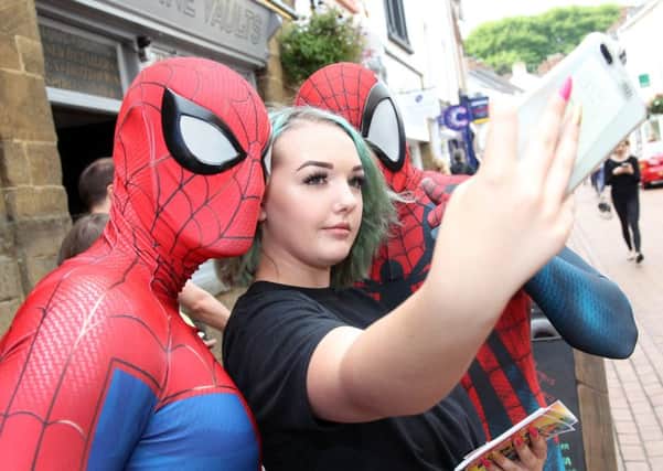 Ebony Cabral gets a selfie with two Spider-Men at the Banbury Old Town Party NNL-180209-191351009