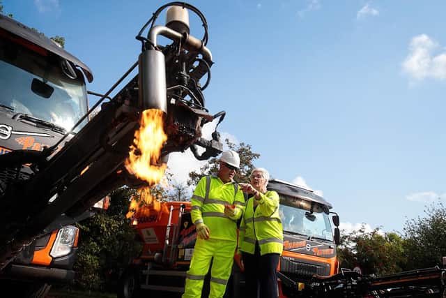 Dragon Patcher operator Tim Harris explains the new machine to Oxfordshire County Council cabinet member for environment Yvonne Constance. Photo: Ric Mellis