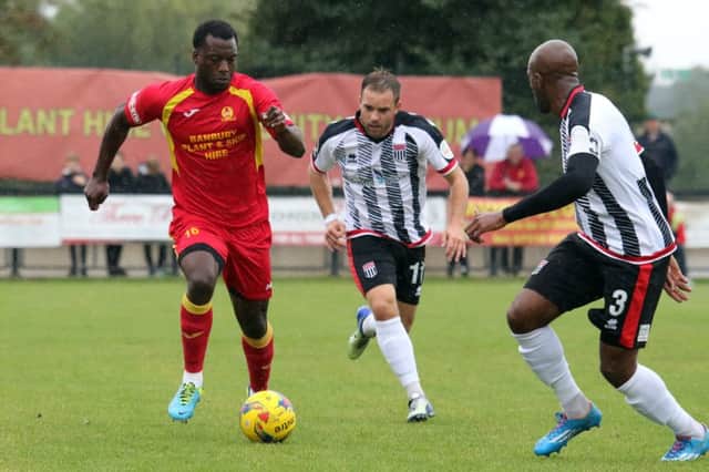 Banbury United's Greg Kaziboni takes on Bath City's Ross Stearn and Anthony Straker in Saturday's Emirates FA Cup tie