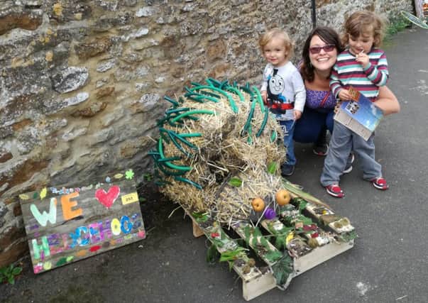 Kings Sutton Scarecrow Festival. Jake and Logan Brock with mum, Emma, with their winning scarecrow hedgehog. Picture by Kevin Kennedy. NNL-170926-094301001