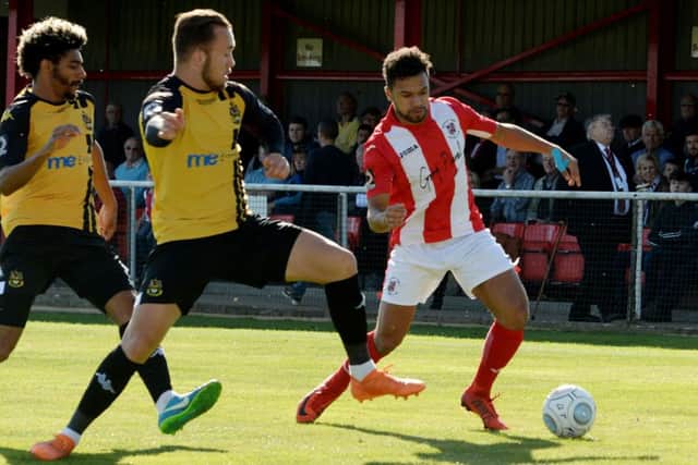Brackley Town's Luke Fairlamb takes on the Southport defence at St James Park