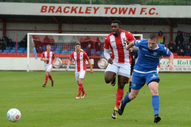 Brackley Town striker Lee Ndlovu is thwarted by Marine's Chris Doyle