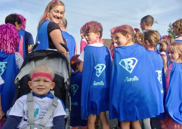 Ruairi Hackland sported a pink headband while his mother Cat and friends wore Super Ru capes to show their support. Photo: Bethan Dennick NNL-180910-113343001