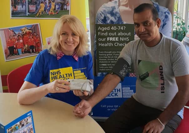 Castle Cars driver Arshad Mehmood undergoing his mini NHS health check with Oxfordshire County Council public health improvement practitioner Liz Benhamou. Photo courtesy of the county council NNL-180910-144219001