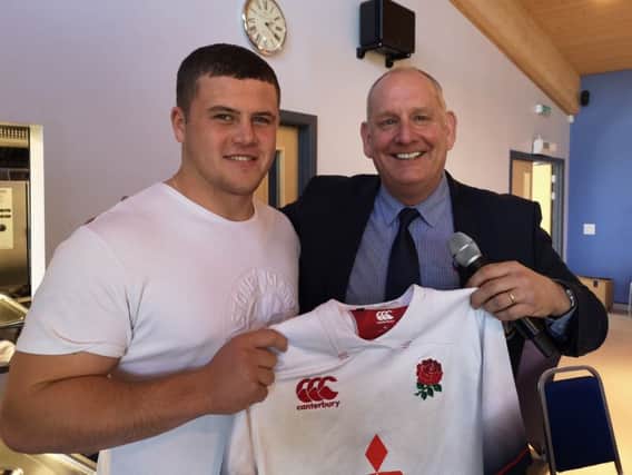 Alfie Barbeary hands one of his England shirts over to Banbury RUFC club president Neil Chapman