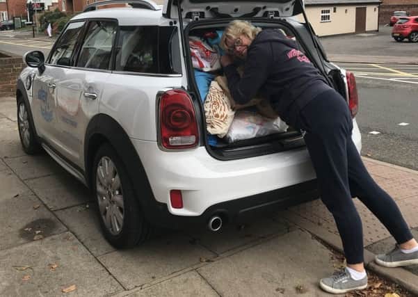 Tamsin Brewis loading Baby Basics donations given by the Banbury Water Babies clients NNL-180111-151012001