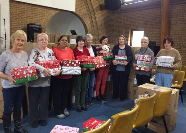 Volunteers at The People's Church who checked and packaged shoeboxes filled with gifts for children overseas NNL-171128-173238001