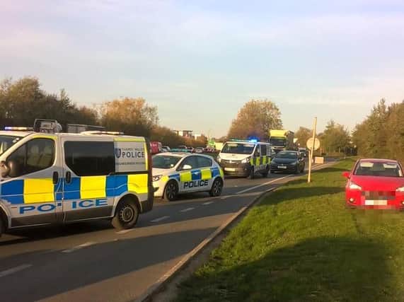 Police cars on the A41 in Bicester after a number of people were found in the back of a trailer. Photo: Thames Valley Police