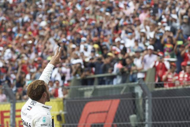 Lewis Hamilton salutes the crowd after clinching his fifth title