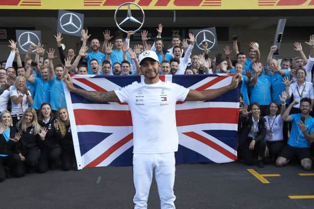 World champion Lewis Hamilton celebrates his title with the Mercedes AMG Petronas team