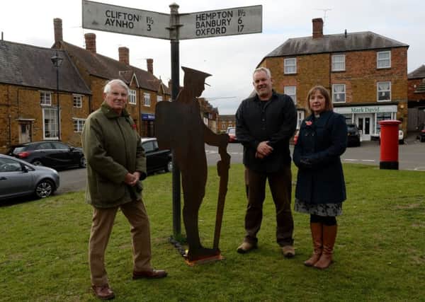 (L-R) Deddington Royal British Legion branch chairman Rob Forsyth, Alex Moss from Forged & Found and Rev Annie Goldthorp with the silhouette