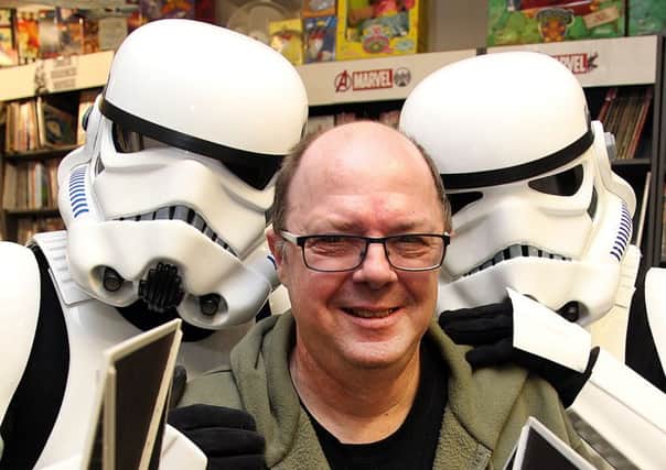 Comic Connections owner Glyn Smith with some familiar characters