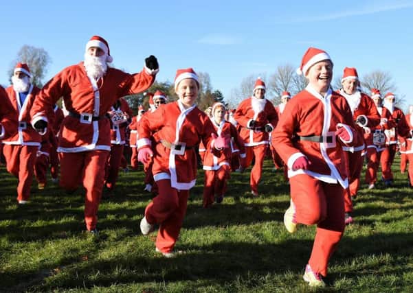Ready, steady, ho! Santas of all ages set off at last year's fun run for Katharine House Hospice. Photo courtesy of the hospice