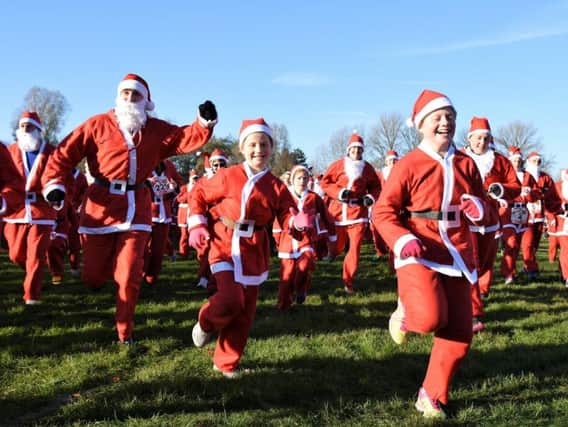 Ready, steady, ho! Santas of all ages set off at last year's fun run for Katharine House Hospice. Photo courtesy of the hospice
