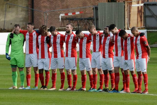 Brackley Town and Blyth Spartans players observe silence for Armistice Day