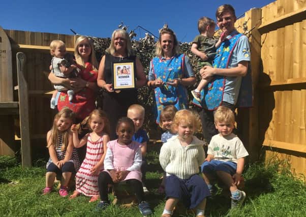 Banbury School Day Nursery director Andrea Brooker (centre left) with staff and children after being voted Banbury Guardian's Nursery of the Year 2018 NNL-181206-105326001