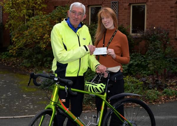 Cyclist, Sean Hagger presents a cheque for Â£300 to Nina Baker of Katharine House Hospice, Adderbury. NNL-181030-161302009