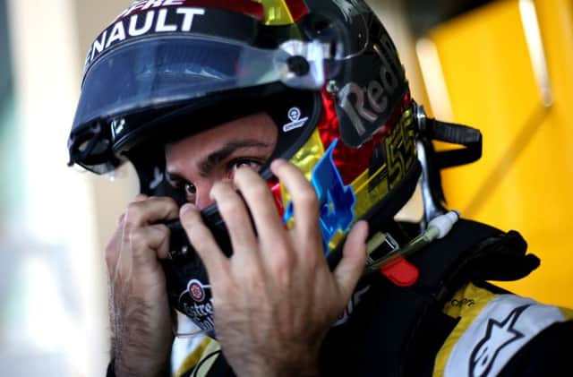 Carlos Sainz takes his helmet off for the final time for the Renault Sports F1 Team after Sunday's Abu Dhabi Grand Prix