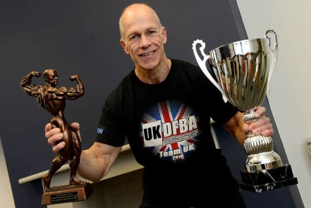 Henry Elsom with his trophies for winning the British and world natural bodybuilding championships