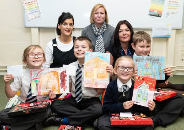 Bloor Homes Sales Manager Emma Bromham (left) and Sales Advisor Beverley James-Hill (right) with William Morris Primary School Assistant Head Teacher Claire Martin (centre) and pupils, from left, Poppy, Tyler, Layla and Aidan NNL-181221-143747001