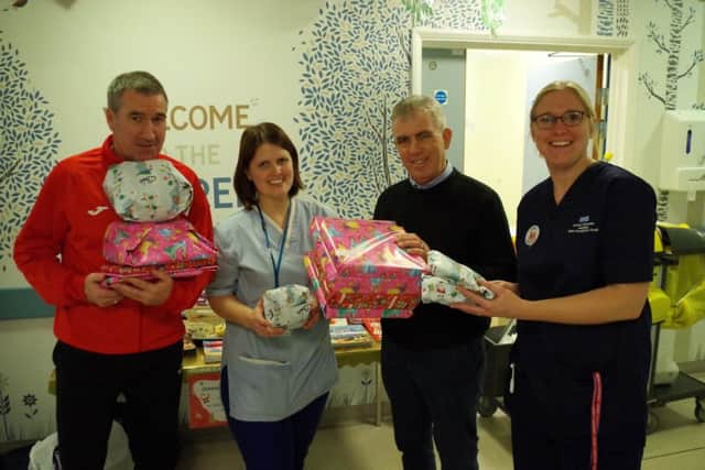 Banbury United manager Mike Ford and chairman Phil Lines with staff on the Childrens' Ward at the Horton General Hospital