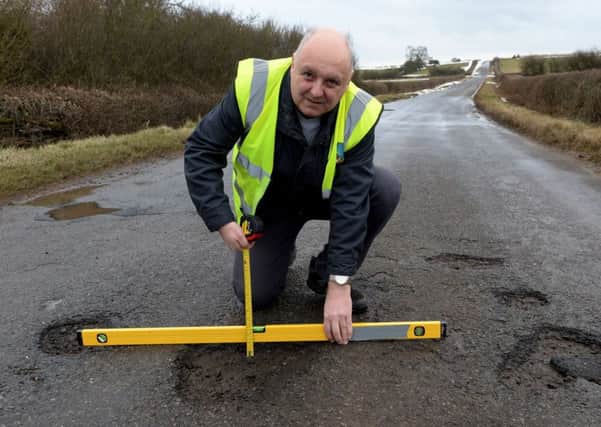 Mr Pothole, Mark Morrell, with potholes between Greatworth and Halse. NNL-180503-160309009