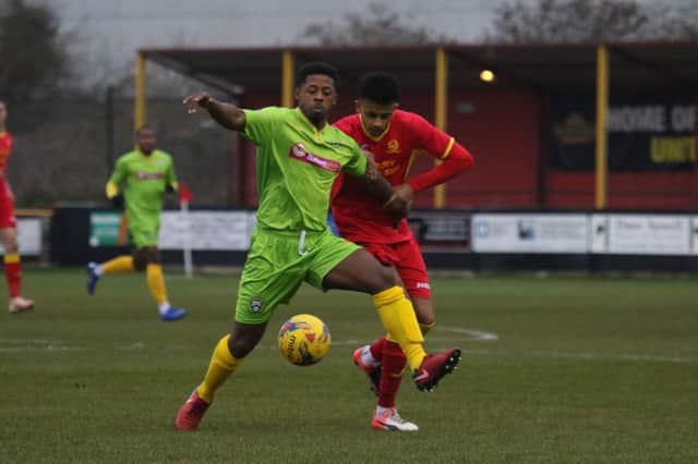 Banbury United's Amer Awadh challenges Barwell's Nigel Julien during Saturday's goal feast. Photo: Steve Prouse