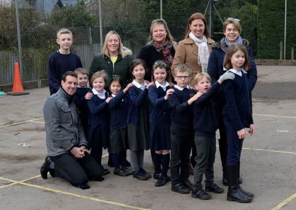 Culworth Primary School Association is raising money to renovate the playground. Ladies of the CPSA, from the left, Emma Bond, Gemma Clowes, Emma Hall and Juliet Nichols with head, Oliver Johnson, bottom left and children from all years at the school. NNL-190129-153503009