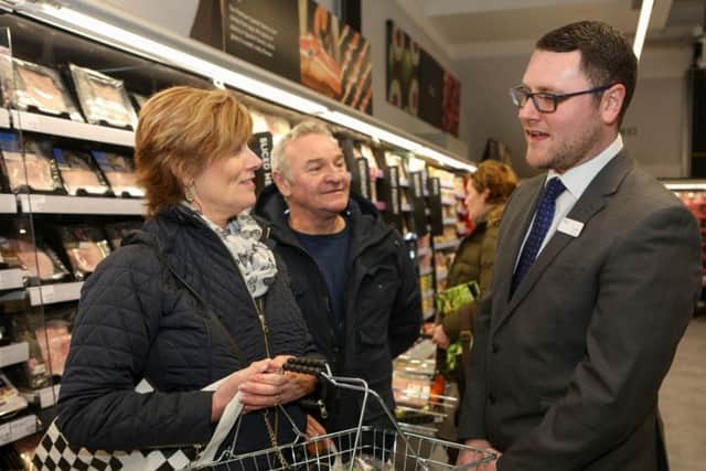 Store manager Lewis Tea (right) with customers Karen and Roger Bagwell. Photo by Anna Lythgoe/Grayling PR