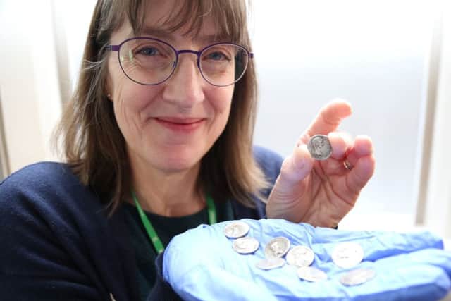 Warwickshire County Council curator of human history Sara Wear with some other Roman coins from the same period as the ones found at Edge Hill NNL-190219-155002001