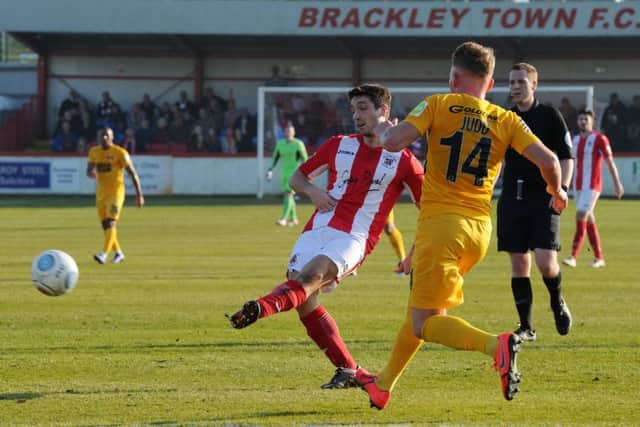Brackley Town's Adam Walker gets his pass away before Leyton Orient's Myles Judd can close him down. Photo: Jake McNulty