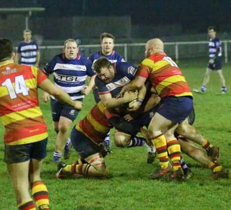 Banbury Bulls' Nick Pratt is held up during Friday's semi-final with Bicester. Photo: Simon Grieve