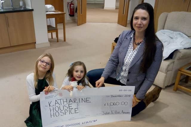 Julie Mills with daughters Elanor and Anwen hand over a cheque to the Katharine House Hospice NNL-190228-134905001
