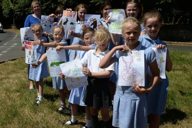 Farthinghoe Primary School head teacher Wendy Whitehouse and pupils with their Twenty's Plenty posters to get motorists to slow down in June, 2018 NNL-180307-141715009
