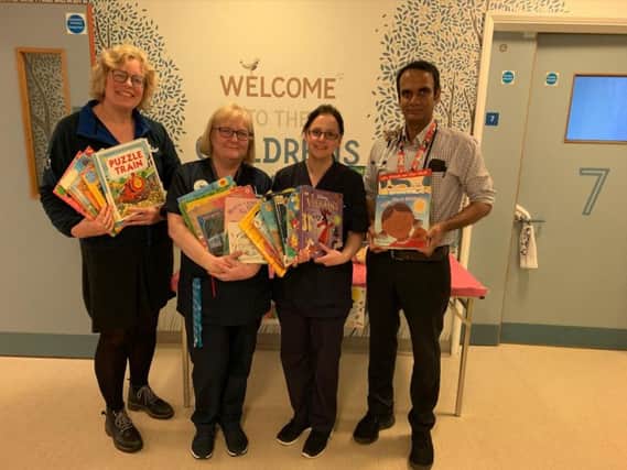 Tamsin Brewis (L) with Horton staff;, senior nurses Izzy Gullick and May Wilson  and Doctor Raj and just a few of the donated books