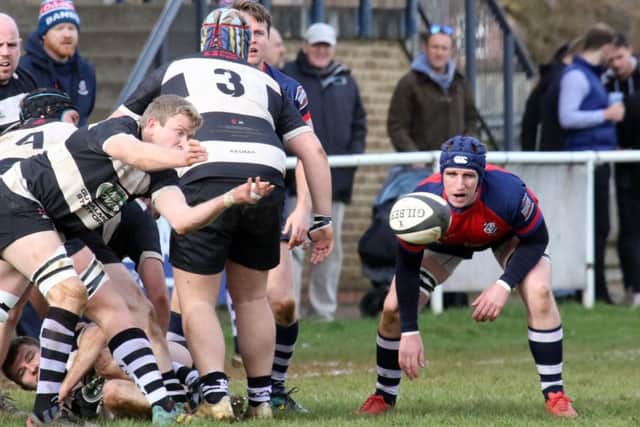 Banbury Bulls' Jacob Mills watches on as Stratford Upon Avon's Matthew Newman clears the ball from the ruck. Photo: Steve Prouse