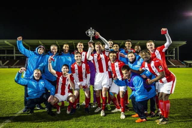 Brackley Town players and staff celebrate their NFA Hillier Cup success at Sixfields