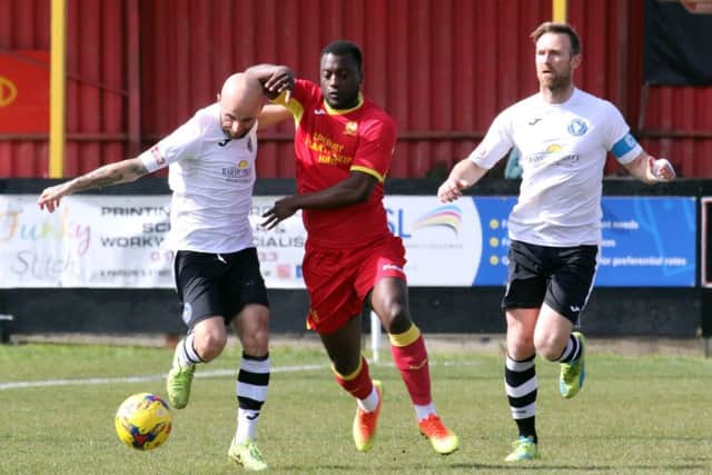 Banbury United's Greg Kaziboni is closed down by King's Lynn Town's Chris Henderson and Ryan Jarvis. Photo: Steve Prouse