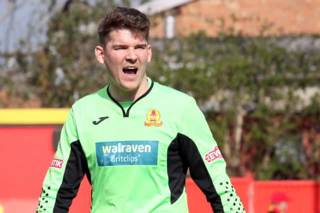 Banbury United keeper Jack Harding urges his side on against King's Lynn Town. Photo: Steve Prouse