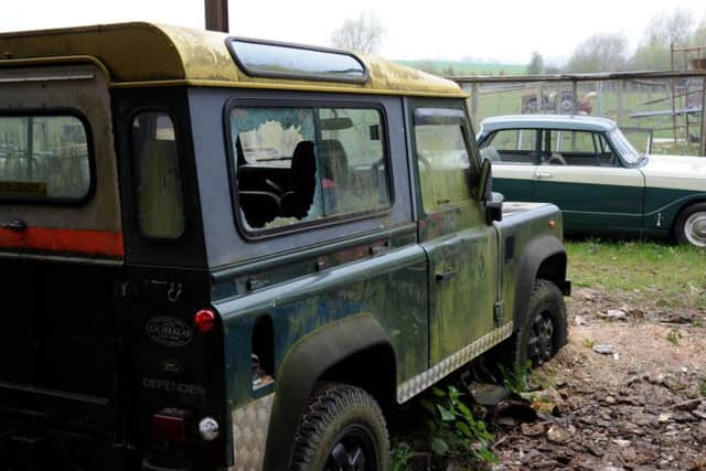 The back windows of a Land Rover Defender were smashed
