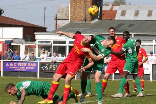 Banbury United's Ricky Johnson and Bedworth United's Barry Fitzharris goes for a header. Photo: Steve Prouse