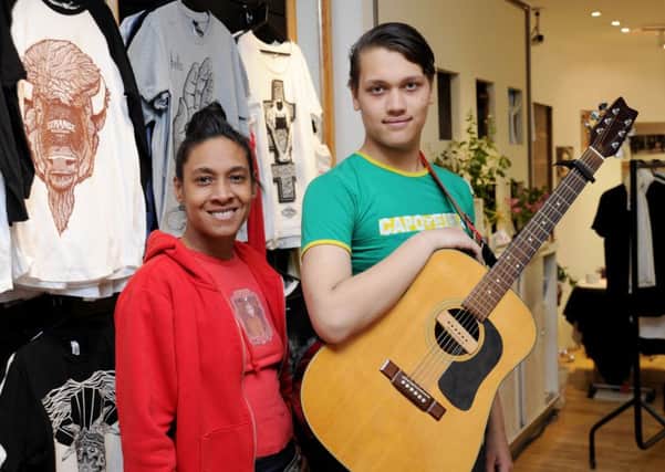 Suzette Neptune and Blue Watson in the Work of Art pop-up space in Castle Quay Shopping Centre, with some of Patrick Curriers T-shirts behind them