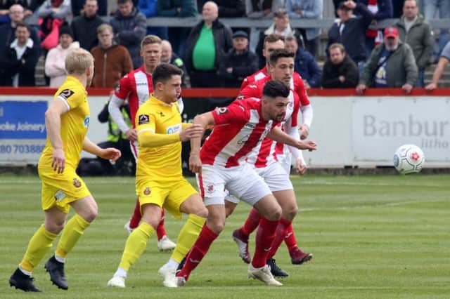 Brackley Town's Connor Hall beats Spennymoor Town's Jamie Chandler to the ball during Sunday's Vanarama National League North play-off semi-final. Photo: Steve Prouse