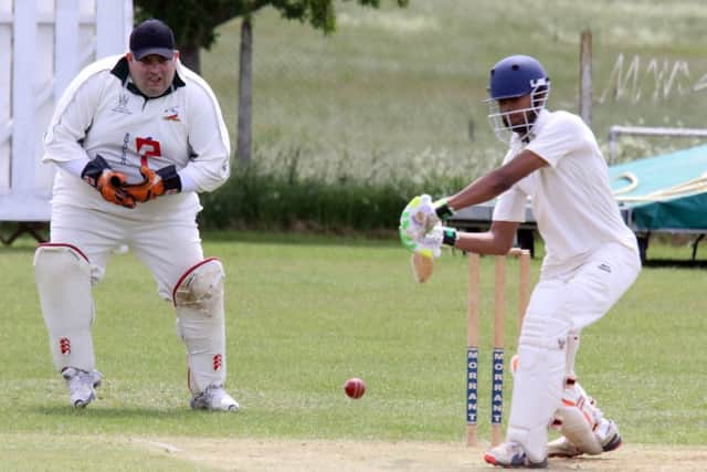 Broughton & North Newington wicket keeper Kevin Walton looks on as Kidlington batsman Sahil Kalyan plays his shot. Photo: Steve Prouse