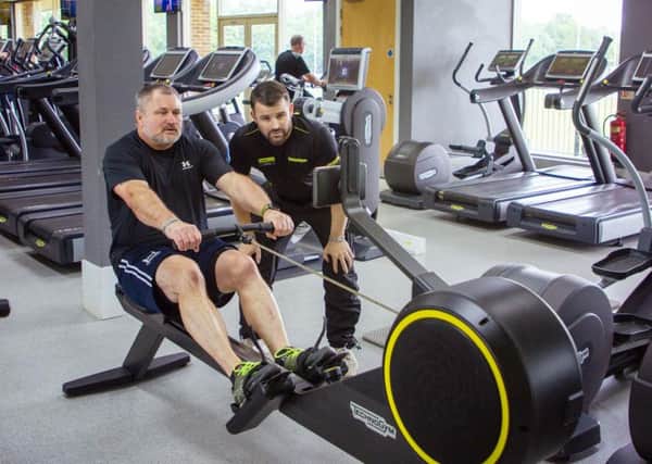 Jay Sullivan working out at Bannatyne's Health Club and Spa with fitness manager Nick Acock. Photo: Bannatyne's Fitness