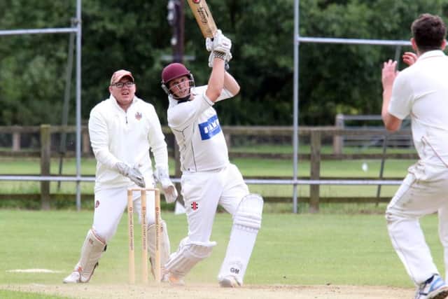 Cropredy batsman Joe Haynes plays his shot as Minster Lovell wicket keeper James Merryman looks on. Photo: Steve Prouse